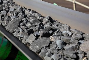 Close up of Manganese rock being moved on a conveyor belt